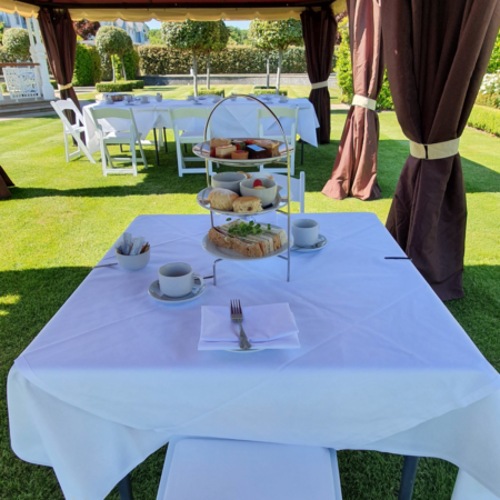 An image of afternoon tea outside at the Hythe Imperial