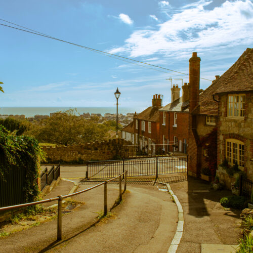 A footpath in Hythe by a row of houses down hill to the sea