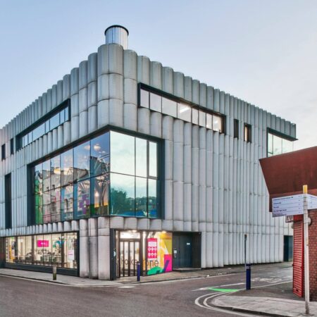 A modern grey building with large glass windows