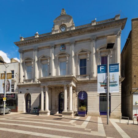 A traditional stone two storey building with columns